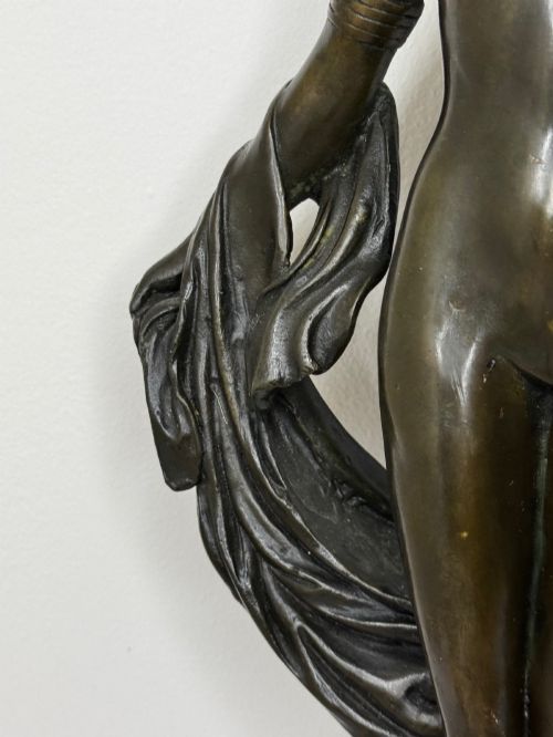 fig 10. A dark brown patinated French bronze sculpture depicting a standing female nude draped in flowing fabric, mounted on a dark marble base.
