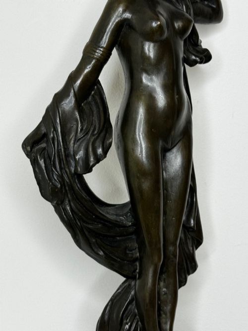 fig 11. A dark brown patinated French bronze sculpture depicting a standing female nude draped in flowing fabric, mounted on a dark marble base.
