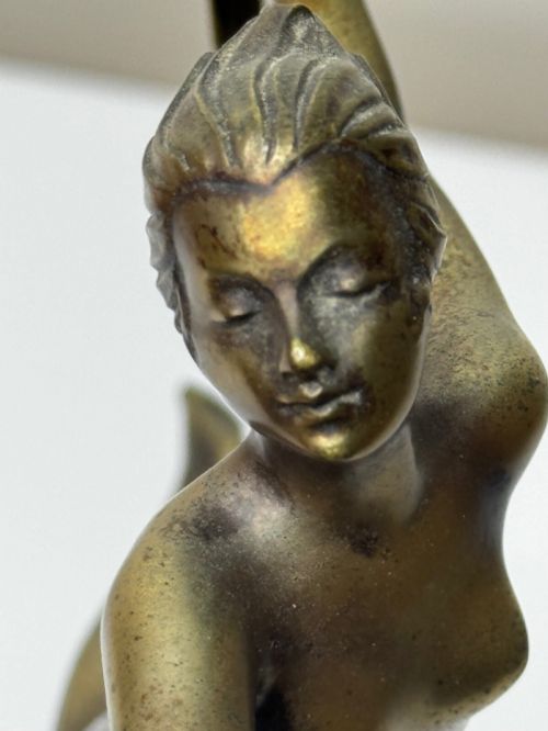 fig 7. An Art Deco bronze sculpture depicting a dancer with draped fabric, mounted on a green onyx pedestal base.