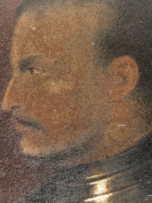 fig 9. An antique profile portrait painting of a man wearing full steel armour, set within an ornate gilded frame decorated with carved shell and scroll motifs.