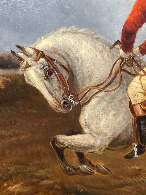 fig 1. An antique Victorian oil painting depicting horse riders in red hunting coats on grey and bay horses, housed within an ornate gilt frame.