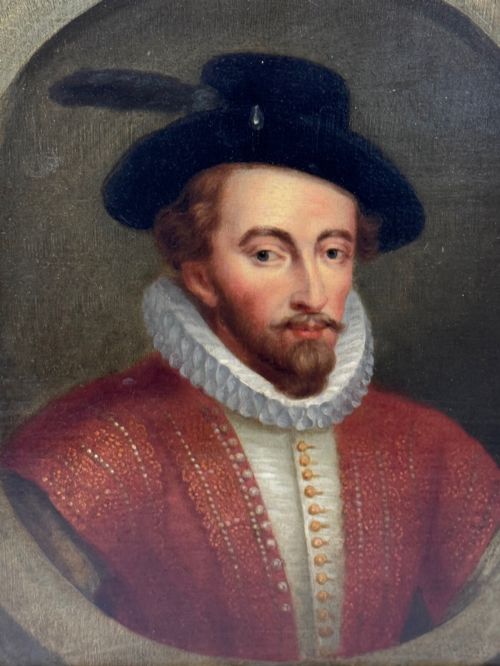 fig 2. An 18th-century oil portrait of a man in a black hat, ruff collar, and crimson doublet set inside a carved gold-gilded frame.