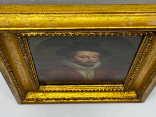 fig 7. An 18th-century oil portrait of a man in a black hat, ruff collar, and crimson doublet set inside a carved gold-gilded frame.