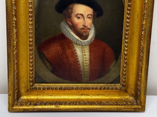 fig 10. An 18th-century oil portrait of a man in a black hat, ruff collar, and crimson doublet set inside a carved gold-gilded frame.
