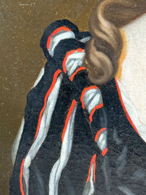 fig 8. An early 18th-century oil portrait of a young woman wearing a dark gown with slashed sleeves, presented in a square giltwood frame with an oval spandrel.