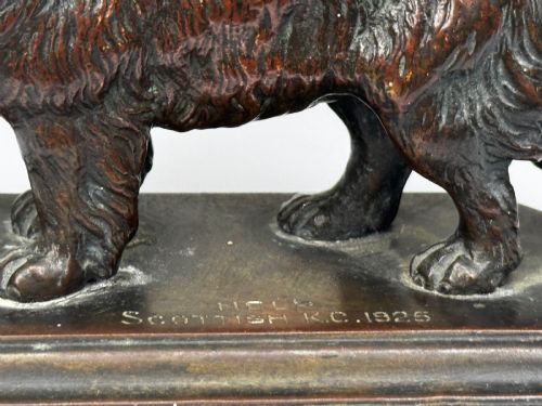 fig 1. A patinated dark bronze sculpture depicting a standing Newfoundland dog positioned on a bevelled rectangular base.