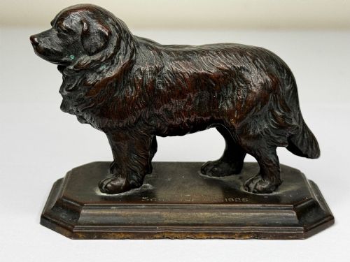 fig 4. A patinated dark bronze sculpture depicting a standing Newfoundland dog positioned on a bevelled rectangular base.