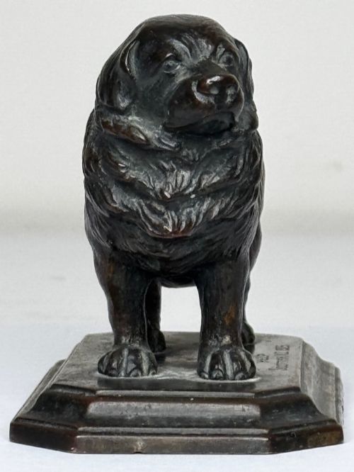 fig 7. A patinated dark bronze sculpture depicting a standing Newfoundland dog positioned on a bevelled rectangular base.