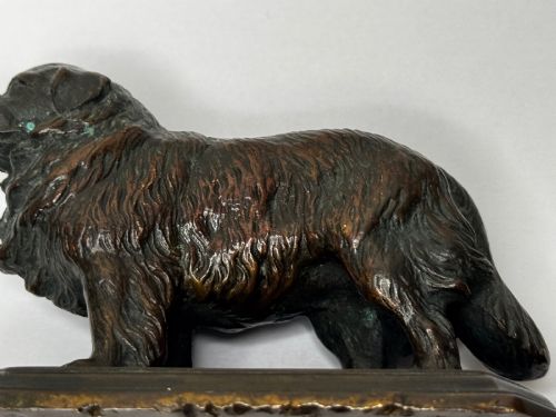 fig 10. A patinated dark bronze sculpture depicting a standing Newfoundland dog positioned on a bevelled rectangular base.