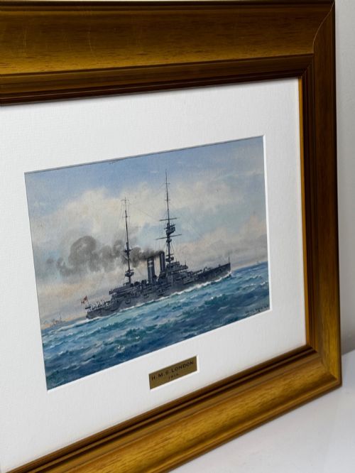 fig 13. A framed watercolour painting depicting the WW1 battleship HMS London at sea, presented in a wide gold gilt frame with a white mount.