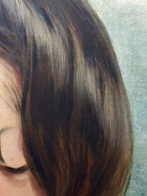 fig 9. A Victorian oil painting on canvas depicting a young woman with dark hair tied with a black ribbon, displayed within an intricate pierced gold gilt frame with an oval aperture.