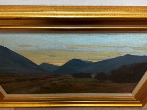 fig 7. An oil painting on canvas depicting a Scottish mountain landscape under a pale yellow sky, framed in a moulded gold frame with a linen inner slip.