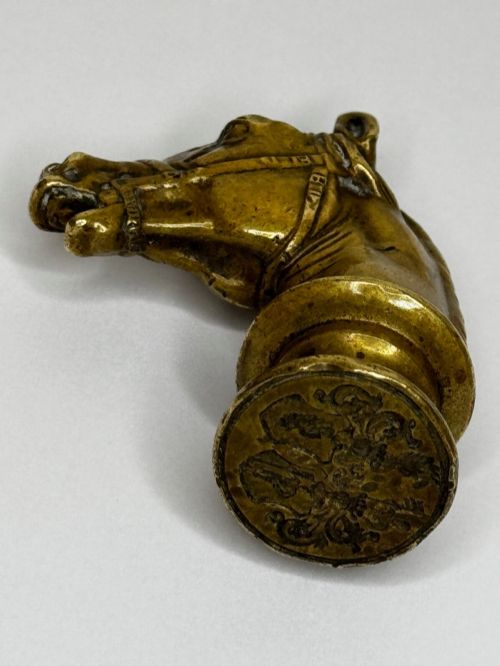 fig 2. A cast brass Georgian desk seal sculpted in the shape of a detailed horse head above a rounded pedestal with an engraved intaglio base.