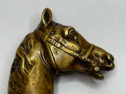 fig 4. A cast brass Georgian desk seal sculpted in the shape of a detailed horse head above a rounded pedestal with an engraved intaglio base.