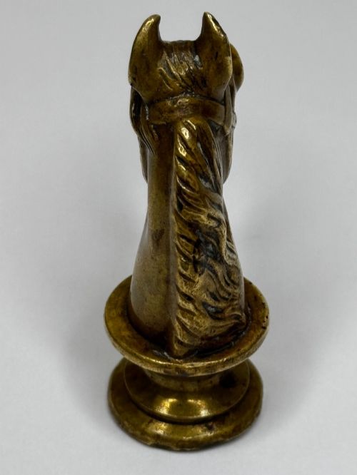 fig 8. A cast brass Georgian desk seal sculpted in the shape of a detailed horse head above a rounded pedestal with an engraved intaglio base.