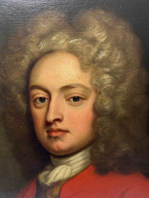 fig 5. An 18th-century oil portrait depicting a gentleman in a red military coat and long curly wig, presented in a carved gold-leaf frame.