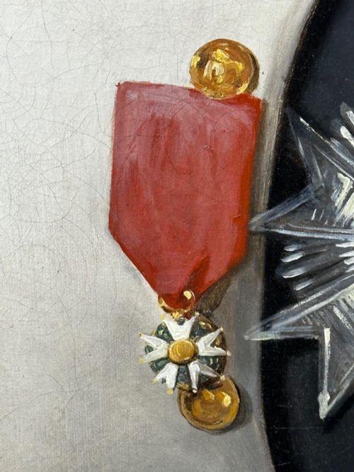 fig 4. A 19th-century oil painting depicting Napoleon I in a military uniform within an oval spandrel and a rectangular gilded frame.