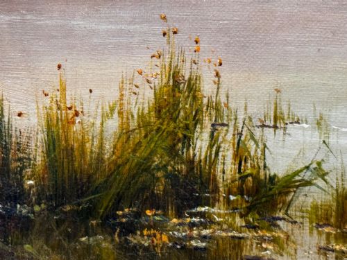 fig 5. An antique oil painting depicting a lake surrounded by mountains at sunset, enclosed within a carved gold frame.