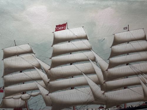 fig 7. A framed oil painting depicting a three-masted sailing ship navigating dark blue seas under a cloudy sky within a gold gilt frame.