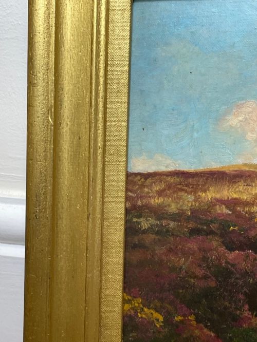 fig 9. An oil painting depicting an open Exmoor moorland with purple heather under a blue sky, set within a wide gilded wooden frame.