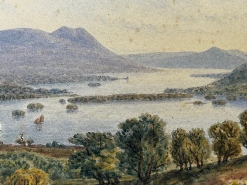 fig 10. An antique Edwardian watercolour painting depicting Lake Windermere with distant hills, trees, and small boats, framed in gilt with a cream mount.