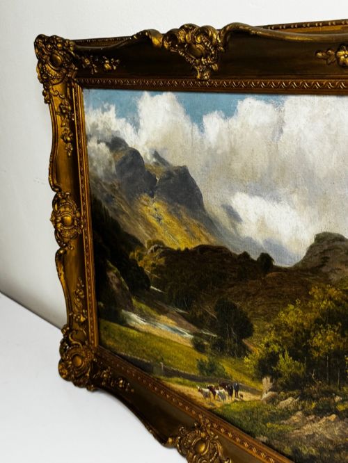 fig 7. A Victorian landscape oil painting depicting a Cumbrian valley with mountains and cattle, set within an ornate gilded frame.