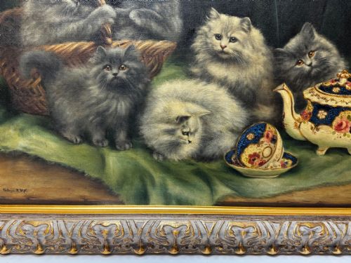 fig 2. An antique framed oil painting depicting five grey and cream Persian kittens positioned around a wicker basket and a floral porcelain teapot.
