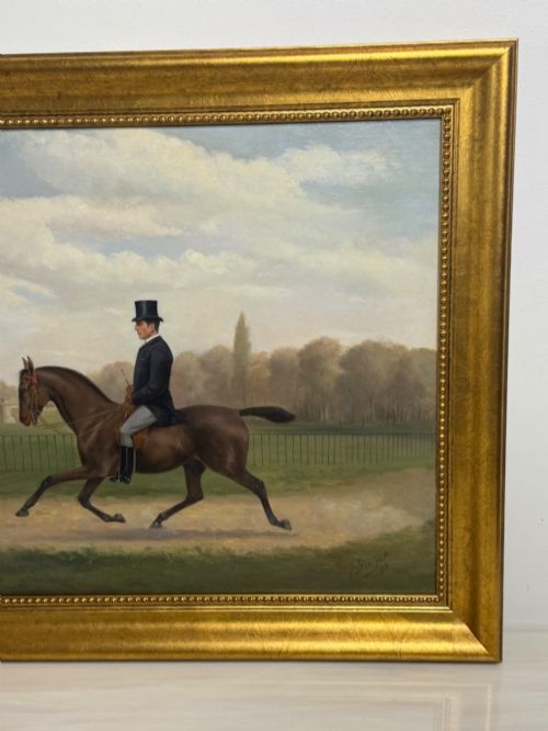 fig 2. A Victorian oil painting depicting a gentleman in formal riding attire atop a brown horse, framed within a wide gold gilded frame.