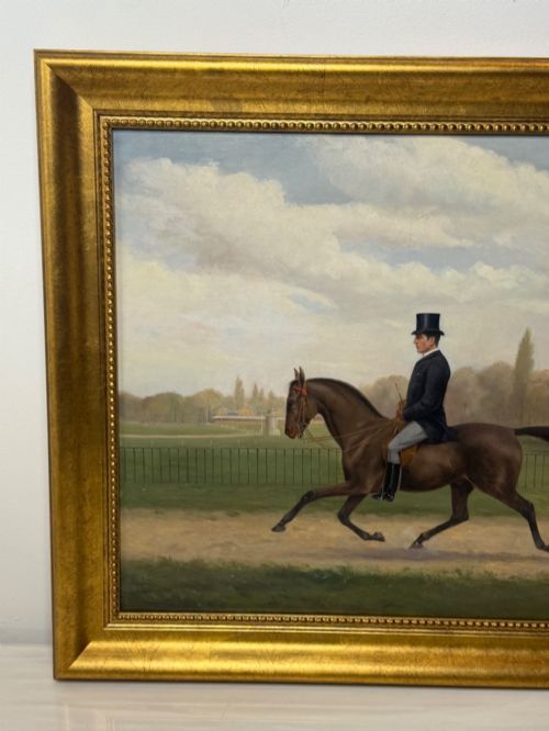 fig 3. A Victorian oil painting depicting a gentleman in formal riding attire atop a brown horse, framed within a wide gold gilded frame.