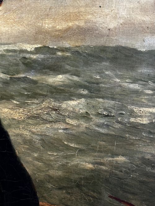 fig 2. An antique oil painting depicting a bearded fisherman in a green knitted jumper sitting in a boat with his catch, encased in a dark wooden frame.