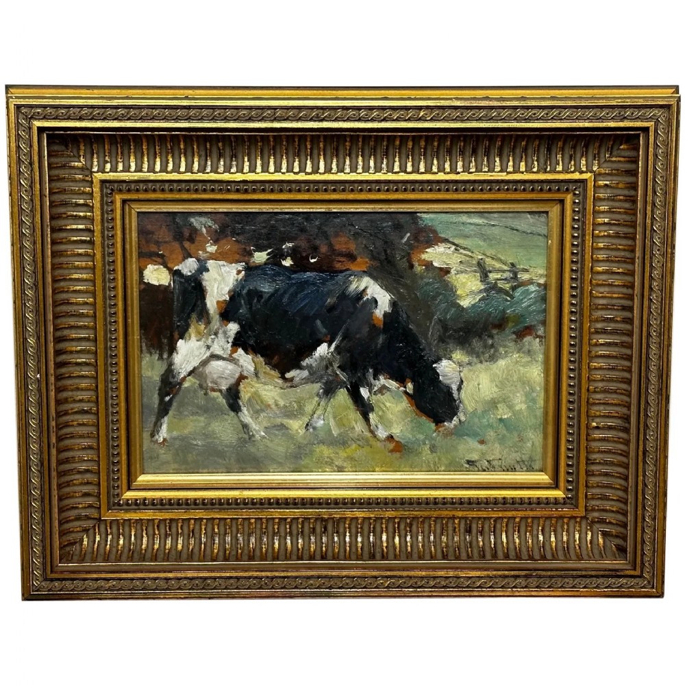 An impressionist oil painting depicting a black and white Friesian cow grazing in a field, set within a heavily moulded gilt frame.