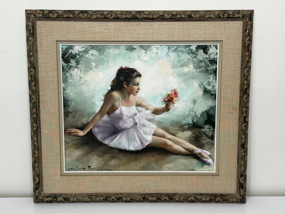 A framed mid-century oil painting depicting a seated ballerina in a white tutu holding a small bouquet of flowers against a textured soft green background. View II