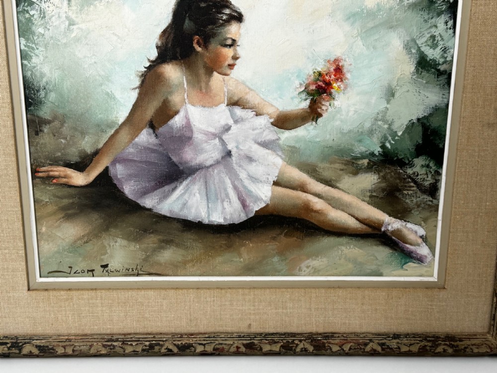 A framed mid-century oil painting depicting a seated ballerina in a white tutu holding a small bouquet of flowers against a textured soft green background. View V
