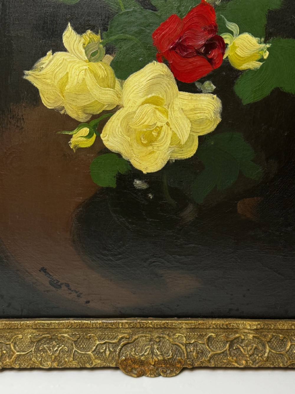 A Victorian floral oil painting depicting yellow and red roses against a dark background, set within a heavy, ornate gold gilded frame. View V