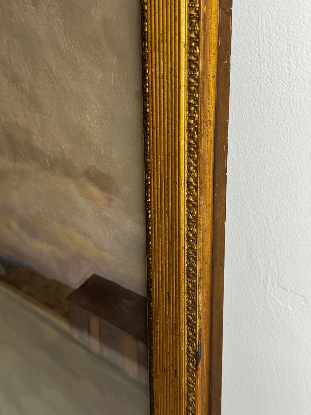A nineteenth-century oil painting depicting a brown thoroughbred horse with a jockey in white and red silks, framed in a ribbed gold-leaf frame. View XIV