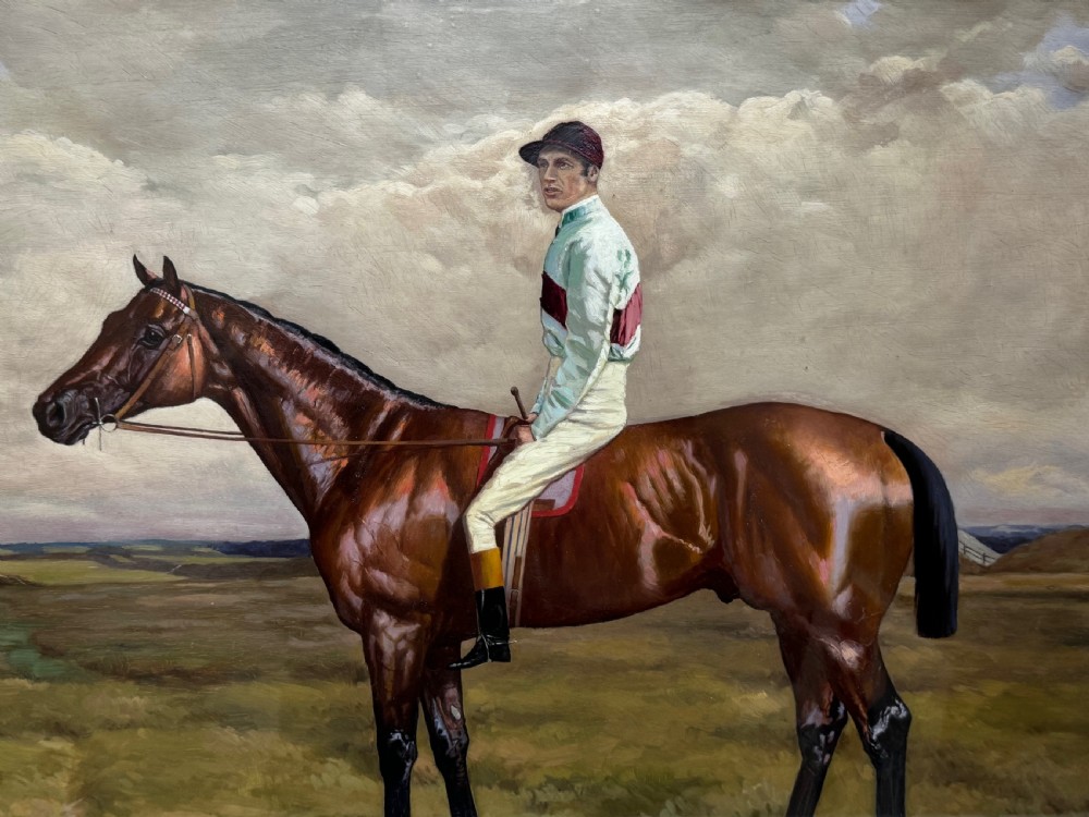A nineteenth-century oil painting depicting a brown thoroughbred horse with a jockey in white and red silks, framed in a ribbed gold-leaf frame. View XVIII