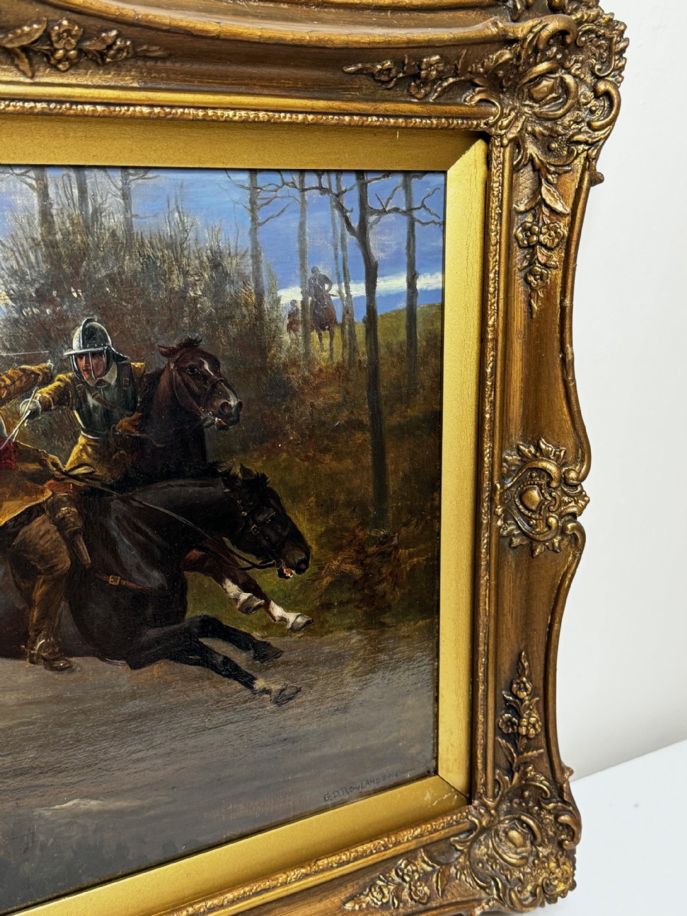 An antique Victorian oil painting featuring a horse chase scene encased within an ornate gilt frame. View V