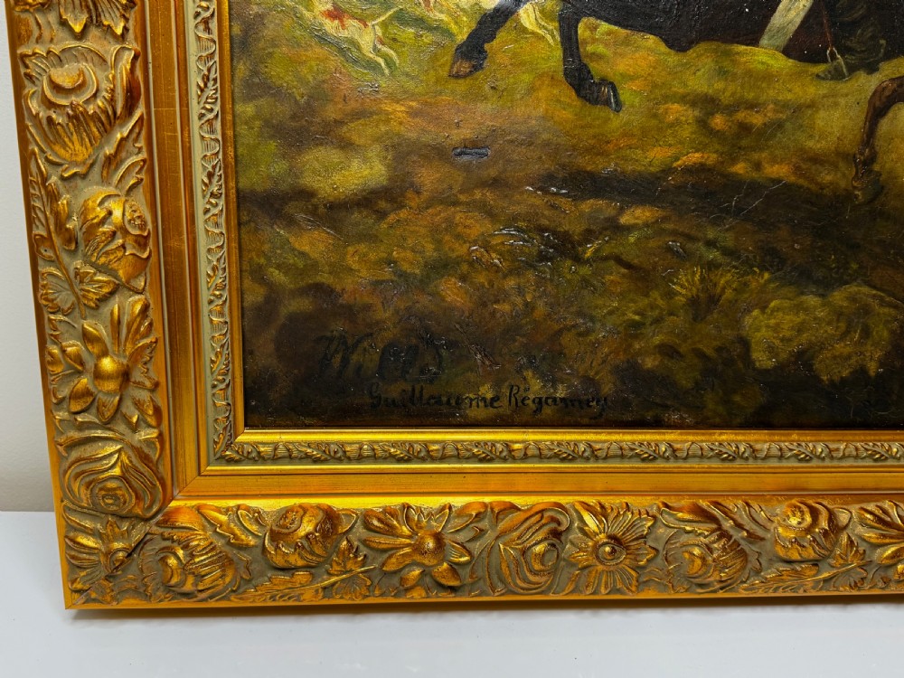 An antique oil painting depicting huntsmen riding horses alongside hounds in an open landscape, housed within an ornate carved gold gilt frame. View X