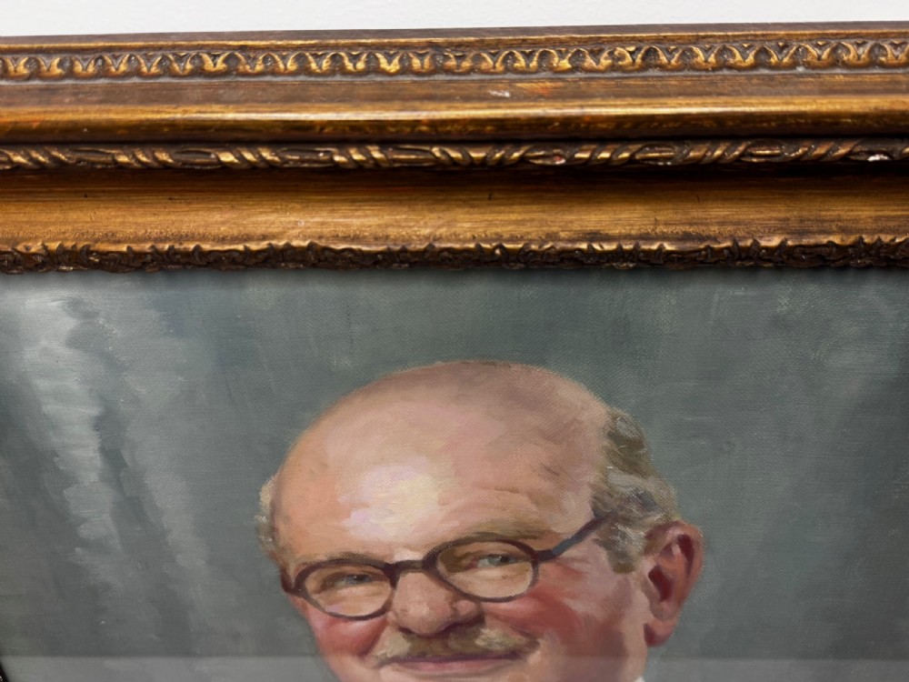 A mid-century oil painting depicting a gentleman wearing glasses, a red coat with dark lapels, and a white bow tie, housed within a gilded wooden frame. View VII