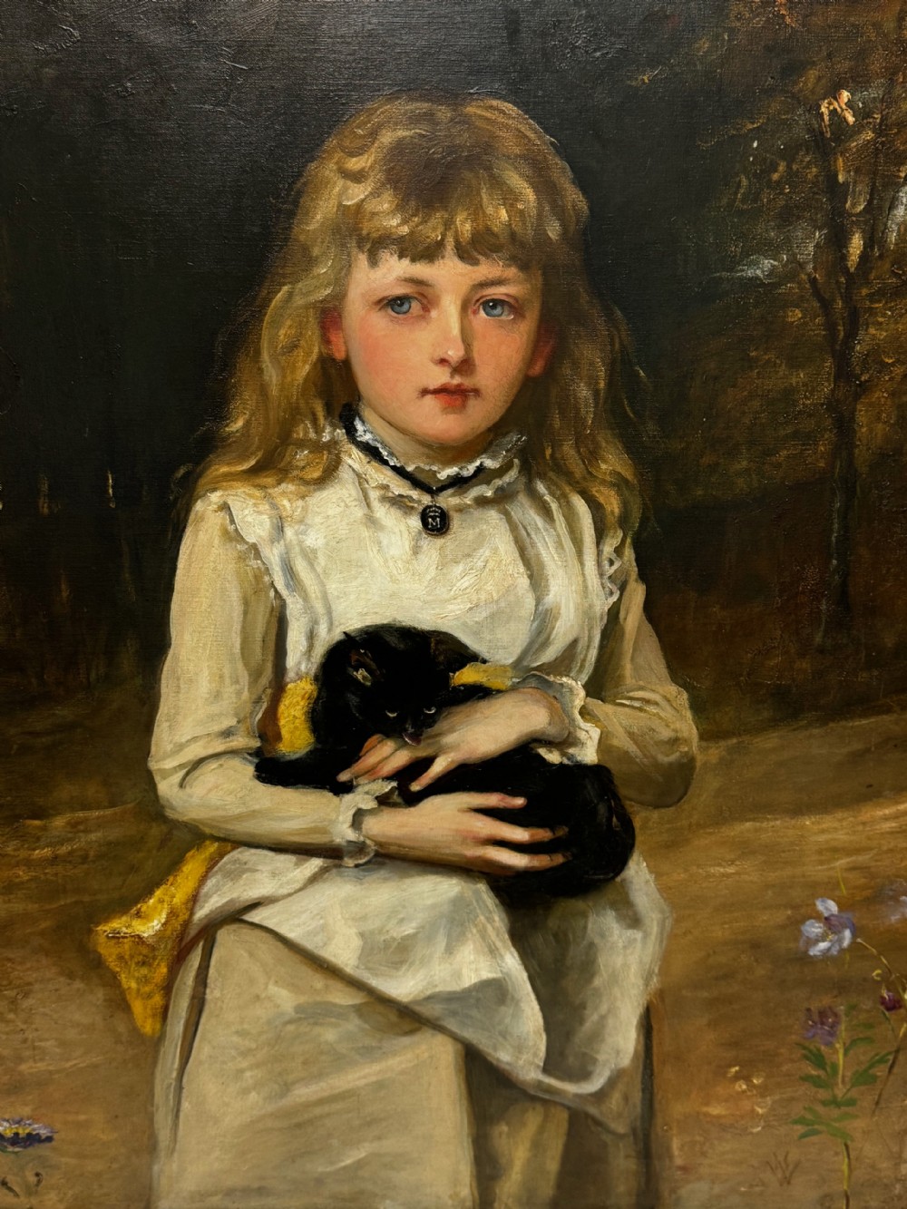 A Victorian oil portrait on canvas depicting a young girl with blonde hair holding a black cat, presented in a carved gold-coloured frame. View VII