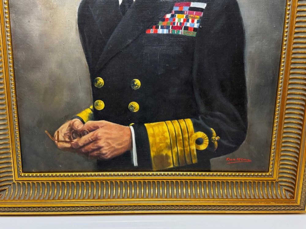 A framed oil painting depicting King George VI in a dark naval uniform with medal ribbons and gold sleeve braid against a grey background. View V