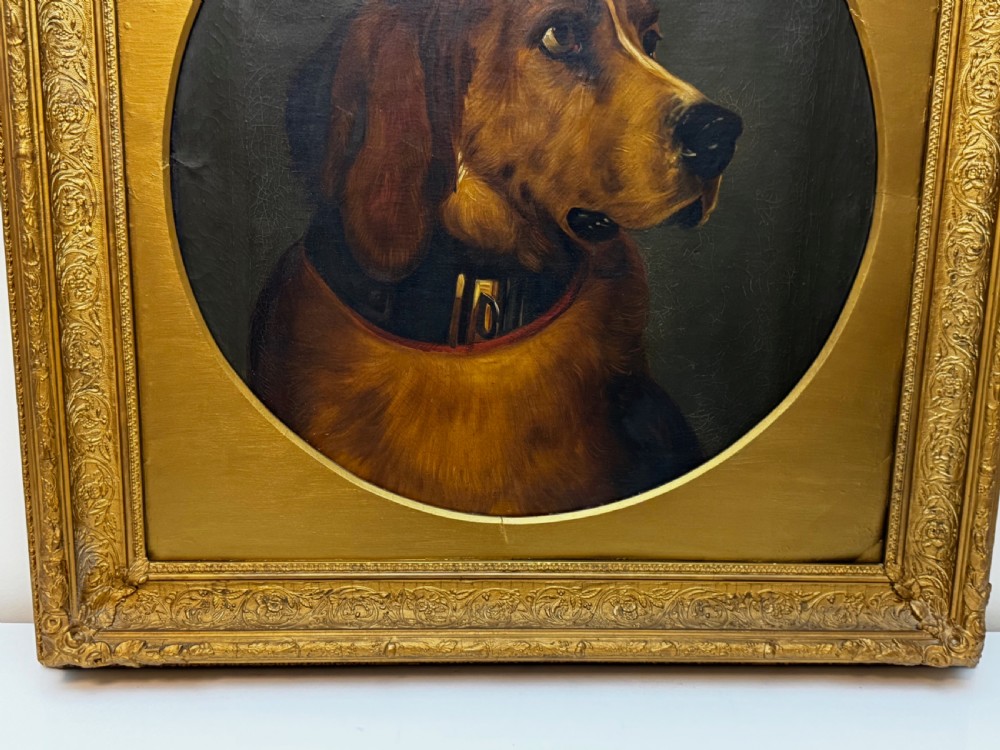 A Victorian oil painting depicting the head profile of a brown hound set inside a circular aperture within a heavy gold gilt frame. View II