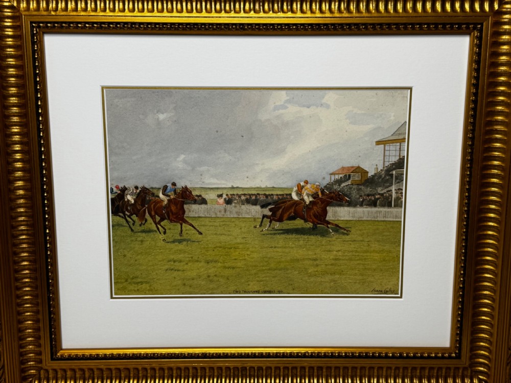 A framed British equestrian painting depicting racehorses and jockeys galloping on a green racetrack at Newmarket within a fluted gold-gilt frame. View XV