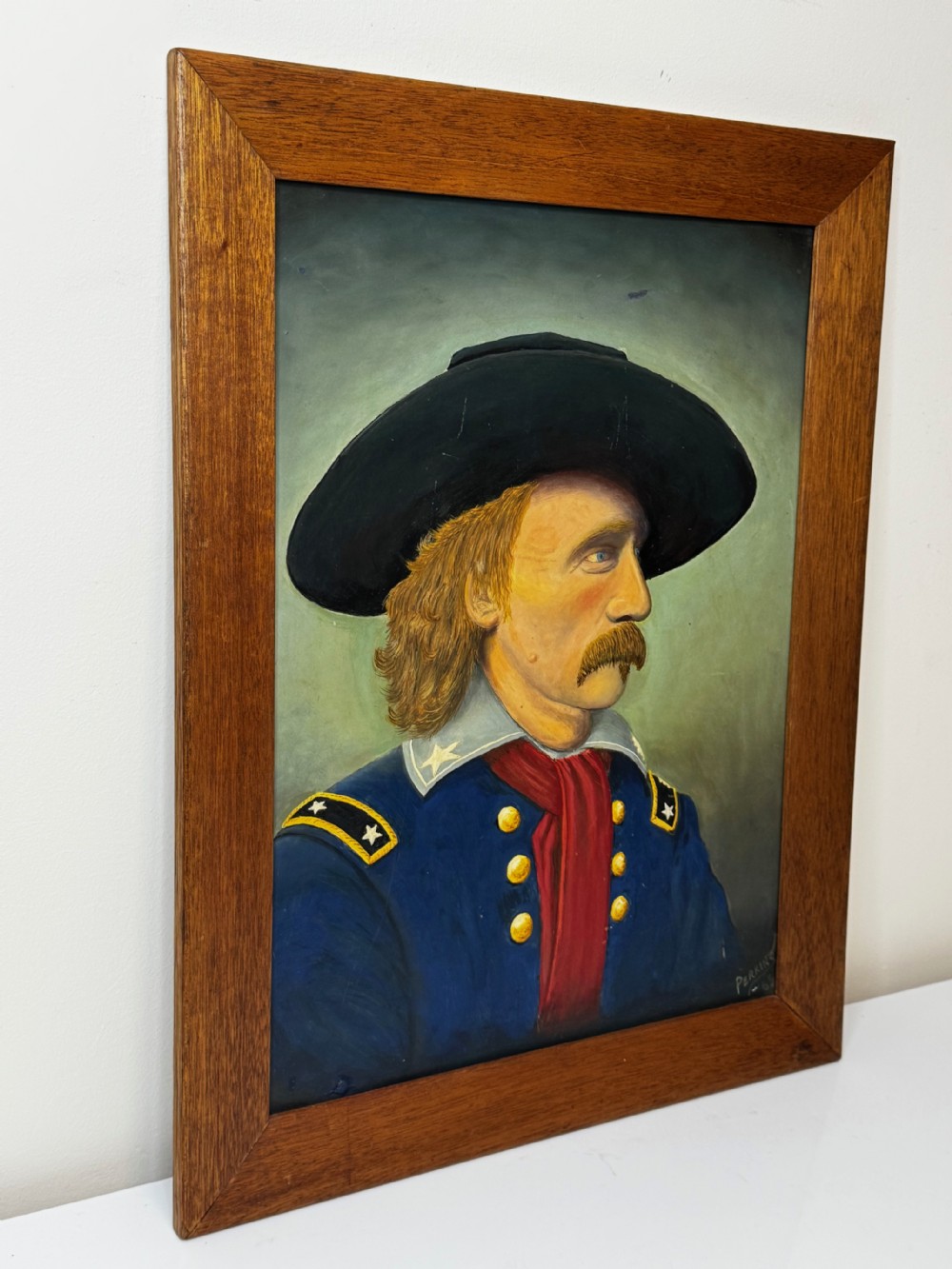 A framed oil painting portraying General George Custer in profile wearing a blue uniform with gold stars and a black hat. View IV