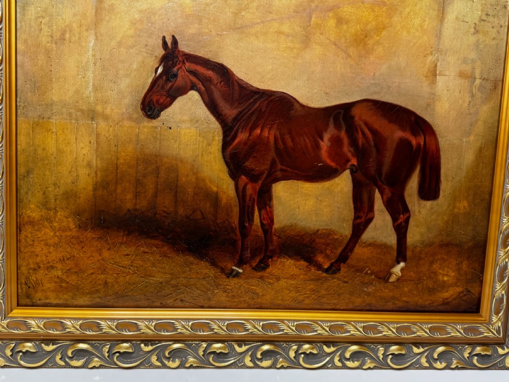 An antique oil painting depicting a standing chestnut brown hunter horse inside a stable, housed within an ornate gilded frame. View VI