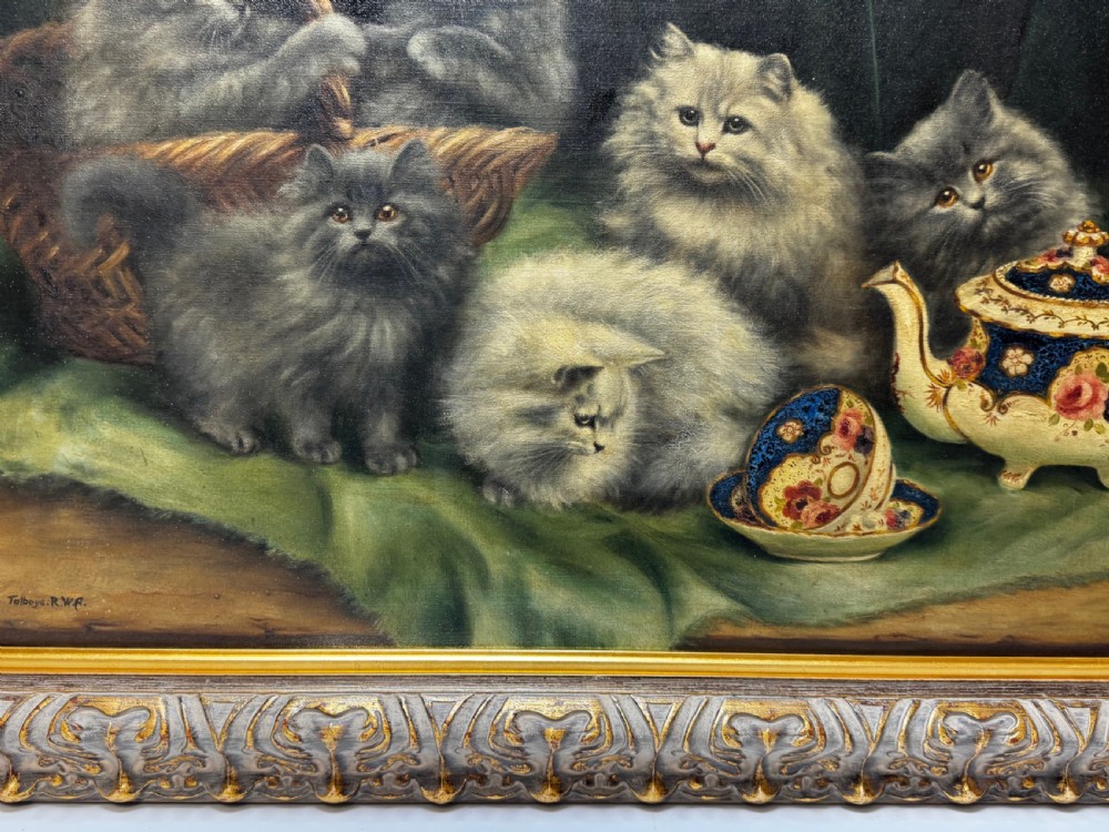 A framed oil painting featuring six fluffy grey and silver Persian kittens arranged around a woven basket and a decorated porcelain teapot. View VIII