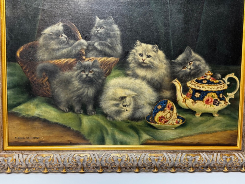 A framed oil painting featuring six fluffy grey and silver Persian kittens arranged around a woven basket and a decorated porcelain teapot. View IX