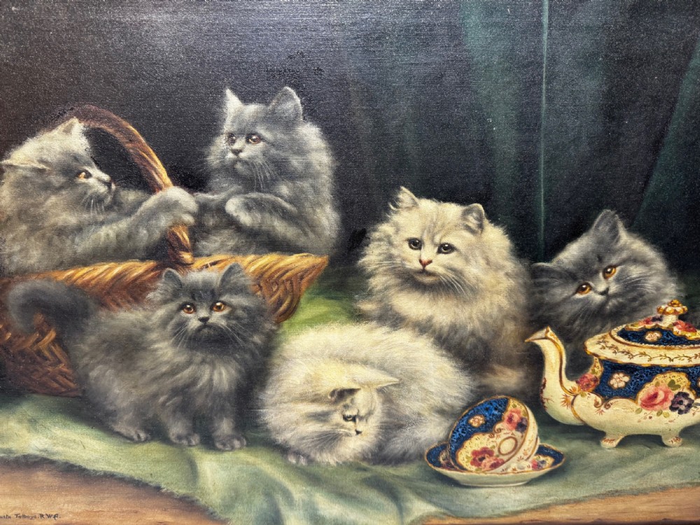 A framed oil painting featuring six fluffy grey and silver Persian kittens arranged around a woven basket and a decorated porcelain teapot. View XIII