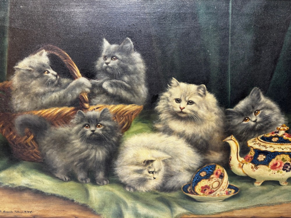 A framed oil painting featuring six fluffy grey and silver Persian kittens arranged around a woven basket and a decorated porcelain teapot. View XV