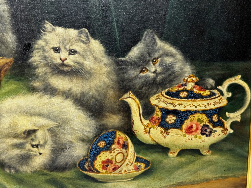 A framed oil painting featuring six fluffy grey and silver Persian kittens arranged around a woven basket and a decorated porcelain teapot. View XVI